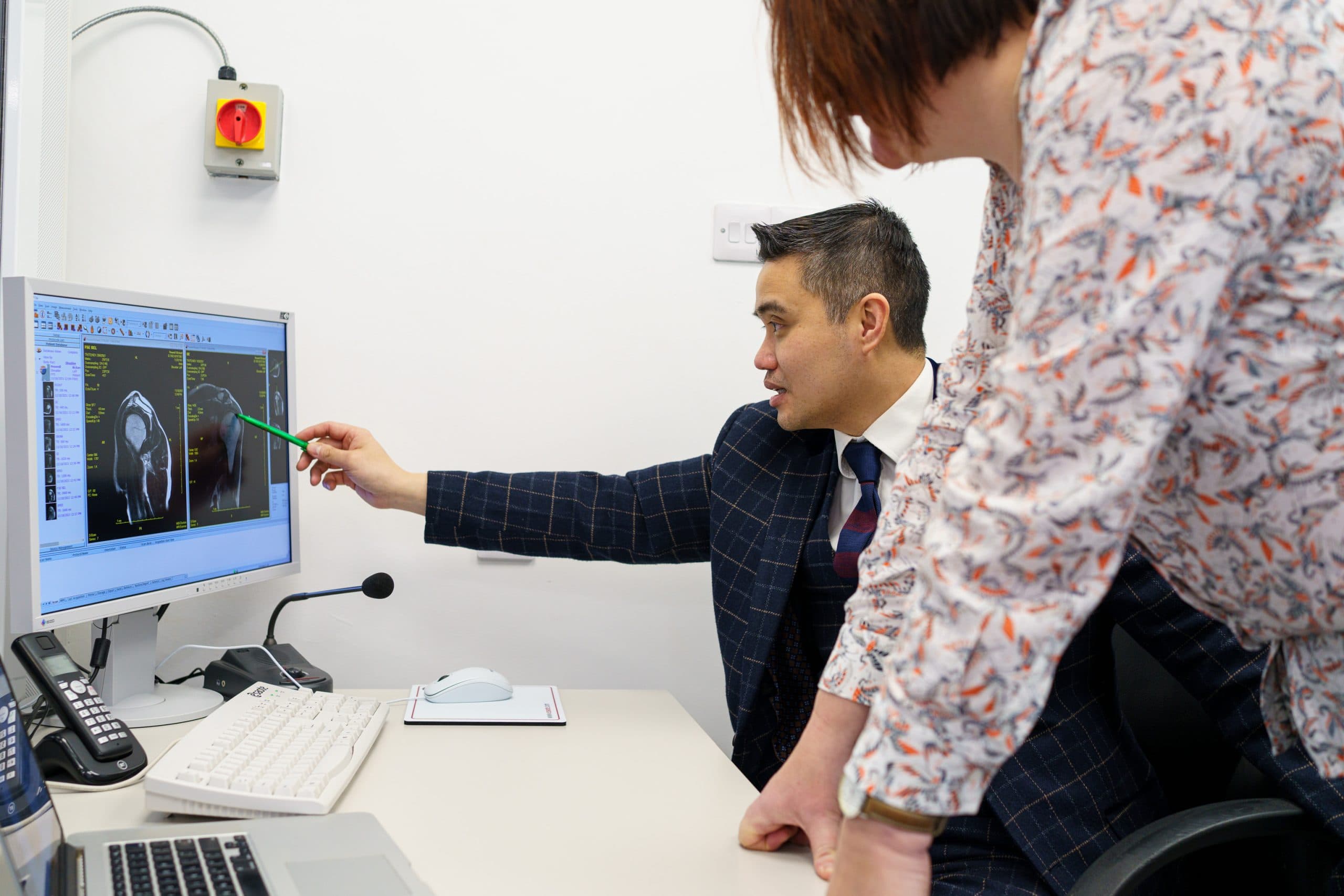 Professor Lee consulting with a patient